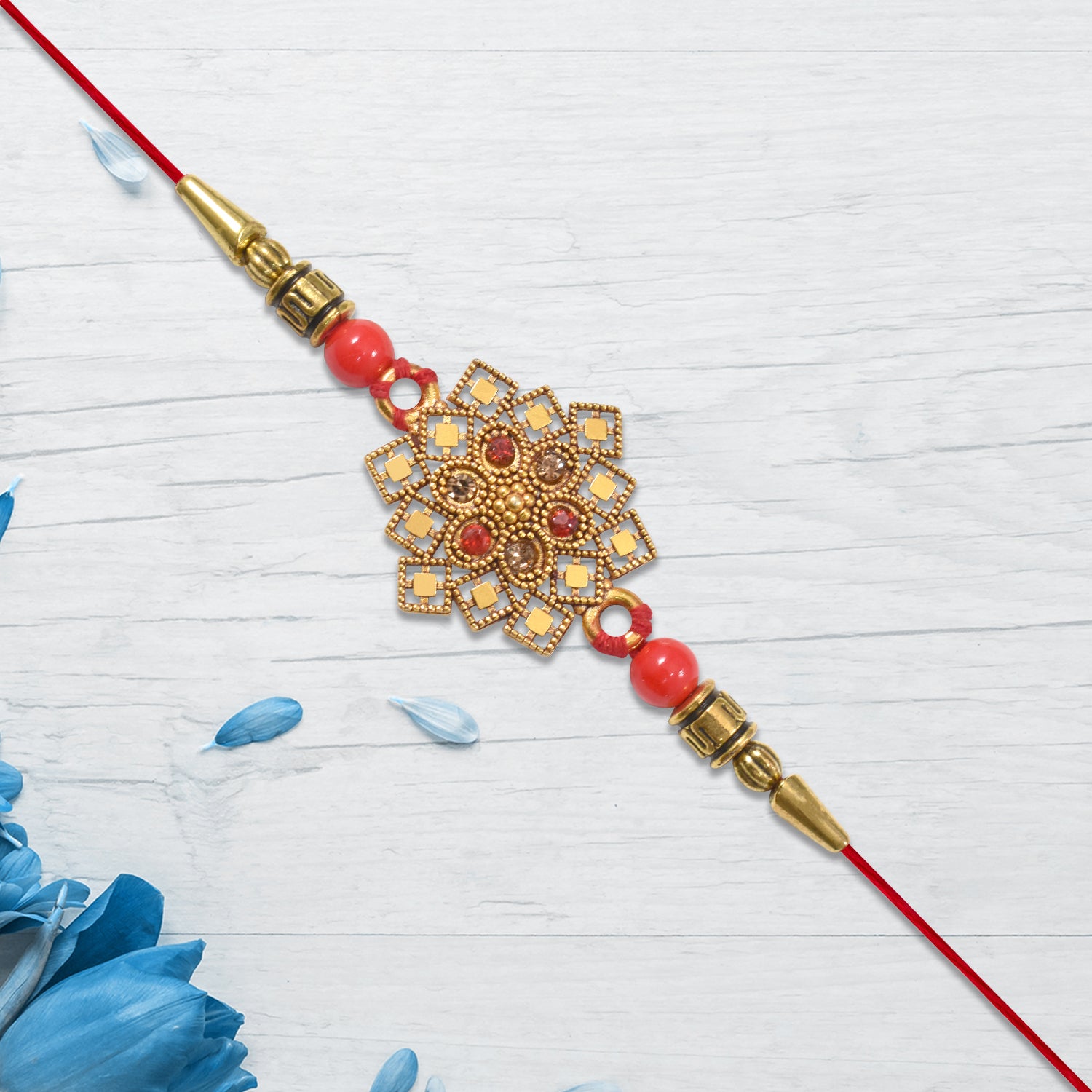 Traditional Golden Floral Rakhi With Intricate Design And Red Beads On Red Thread